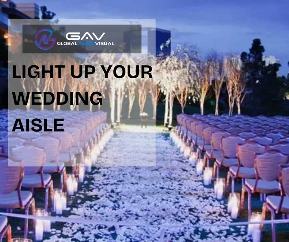 Stunning wedding décor featuring LED walls and projection mapping with glowing aisle flowers, elegant lighting, and floral centerpieces under soft spring wedding colors.