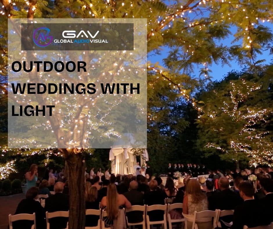 Stunning wedding décor featuring LED walls and projection mapping with glowing aisle flowers, elegant lighting, and floral centerpieces under soft spring wedding colors.