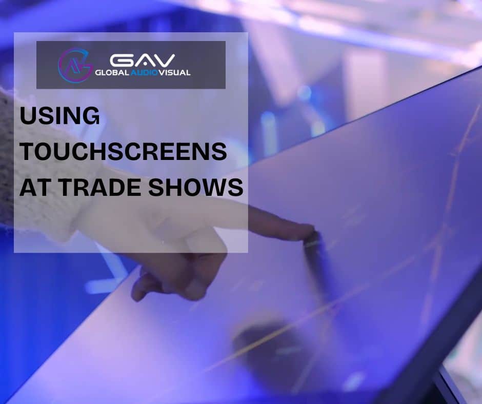 Interactive Displays & Touchscreens at an event booth with people engaging in games, presentations, and team activities.