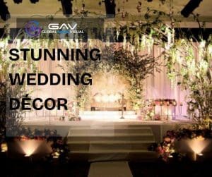Stunning wedding décor featuring LED walls and projection mapping with glowing aisle flowers, elegant lighting, and floral centerpieces under soft spring wedding colors.